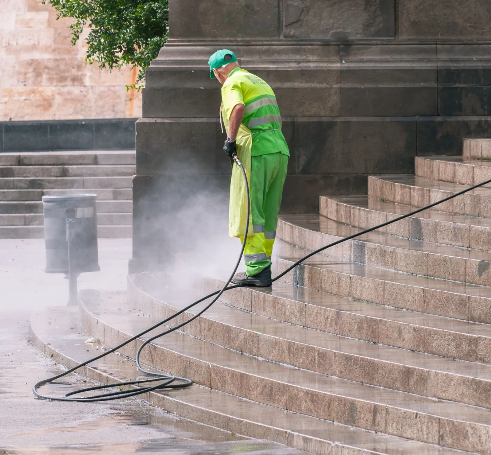 Power washing a concrete surface to remove dirt and stains by Ortiz Concrete Services